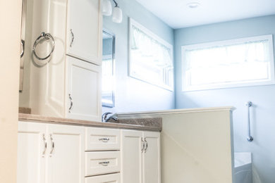 Inspiration for a transitional master vinyl floor bathroom remodel in Other with recessed-panel cabinets, white cabinets, green walls, an undermount sink and onyx countertops