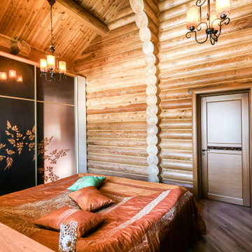 Спальная комната в деревянном доме из оцилиндрованного бревна