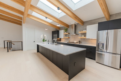 Large mid-century modern single-wall light wood floor, beige floor and exposed beam kitchen photo in Other with a drop-in sink, flat-panel cabinets, black cabinets, quartz countertops, gray backsplash, cement tile backsplash, stainless steel appliances, an island and white countertops