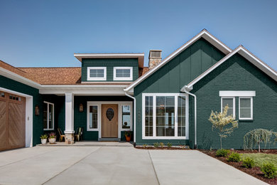 Example of a classic green one-story mixed siding exterior home design in Salt Lake City with a shingle roof