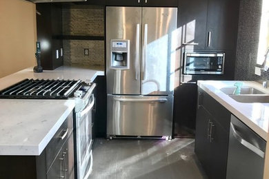 Enclosed kitchen - mid-sized contemporary u-shaped gray floor enclosed kitchen idea in Los Angeles with flat-panel cabinets, brown cabinets, marble countertops, stainless steel appliances, a double-bowl sink, matchstick tile backsplash and white countertops