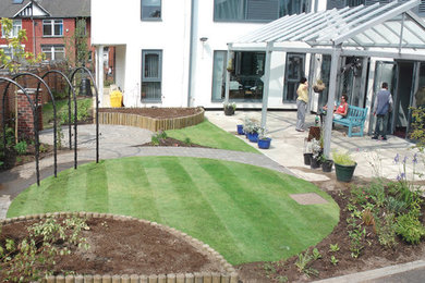 Medium sized contemporary courtyard formal full sun garden for summer with a vegetable patch and brick paving.