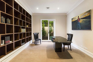 Mid-sized contemporary home office in Melbourne with a library, carpet and a freestanding desk.
