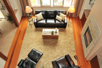 Example of a transitional open concept medium tone wood floor living room design in Sacramento with beige walls, a standard fireplace and a tile fireplace