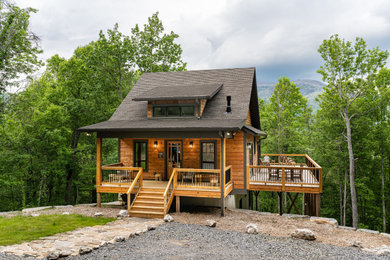 Mid-sized arts and crafts three-story wood and clapboard exterior home photo in Other with a shingle roof and a brown roof