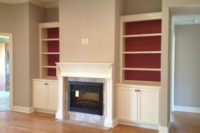 Family room - traditional open concept light wood floor family room idea in Miami with beige walls, a tile fireplace and a wall-mounted tv