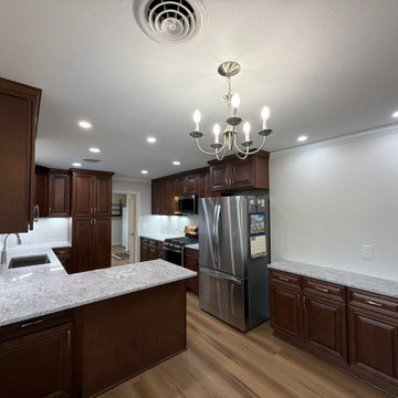 USCD cabinetry accompanied granite countertops, porcelain tile backsplash and Ca