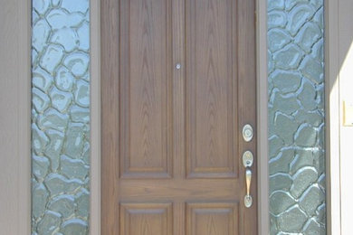 Entryway - large transitional entryway idea in Kansas City with a medium wood front door