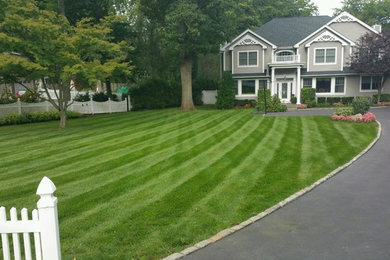 Design ideas for a large traditional full sun front yard concrete paver formal garden in New York.
