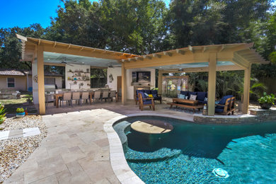 Inspiration for a large contemporary backyard stone pool remodel in Orlando
