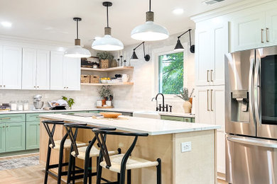 Example of a large transitional u-shaped vinyl floor, beige floor and coffered ceiling eat-in kitchen design in DC Metro with a farmhouse sink, shaker cabinets, green cabinets, quartzite countertops, white backsplash, porcelain backsplash, stainless steel appliances, an island and white countertops