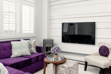 Family room - contemporary medium tone wood floor family room idea in Toronto with white walls and a wall-mounted tv