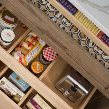 A Breakfast Center Station in a Base Cabinet with Powered Roll-Out Shelves