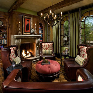 Inspiration for a medium sized modern home office and library in Orange County with a reading nook, green walls, medium hardwood flooring, a standard fireplace, a stone fireplace surround and brown floors.