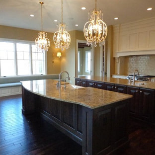 Large kitchen pantry remodeling - Example of a large single-wall dark wood floor kitchen pantry design in Cedar Rapids with a single-bowl sink, granite countertops, beige backsplash, stainless steel appliances and two islands