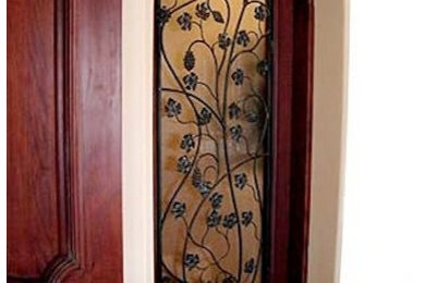 Inspiration for a mid-sized mediterranean entryway remodel in Los Angeles with a medium wood front door and beige walls