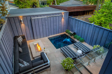 Patio - small contemporary backyard stone patio idea in Toronto with a fire pit