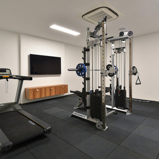 Large modern multi-use home gym in Brisbane with white walls and grey floors.