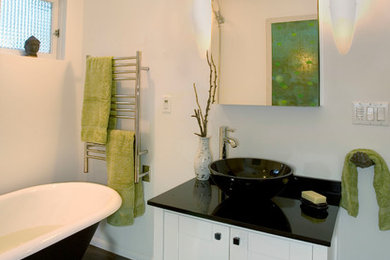 Inspiration for a mid-sized contemporary master dark wood floor and brown floor bathroom remodel in Portland with shaker cabinets, white cabinets, a two-piece toilet, white walls, a vessel sink and solid surface countertops