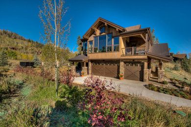 Example of a huge transitional multicolored two-story mixed siding exterior home design in Other with a mixed material roof