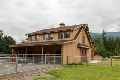 This is an example of a large country two-storey brown house exterior in Seattle with wood siding and a gable roof.