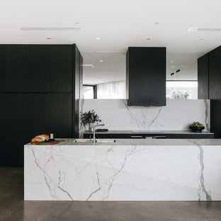 Contemporary galley eat-in kitchen in Adelaide with an undermount sink, flat-panel cabinets, black cabinets, white splashback, panelled appliances, concrete floors, with island, grey floor and white benchtop.
