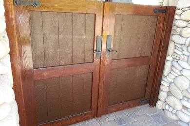 Inspiration for a mid-sized rustic slate floor entryway remodel in San Diego with multicolored walls and a medium wood front door