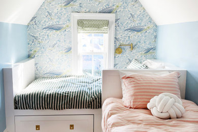 Example of a large beach style gender-neutral light wood floor, brown floor and wallpaper kids' room design in Providence with blue walls