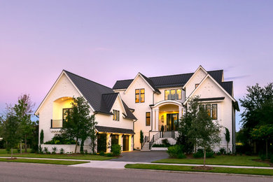 Transitional white two-story brick exterior home idea in Charleston with a metal roof