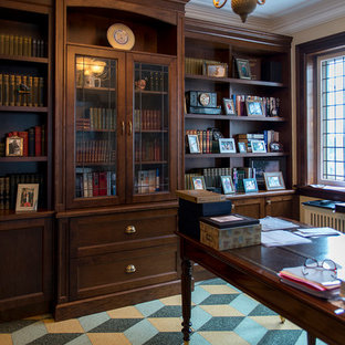 Design ideas for a mid-sized traditional home office in Toronto with a library, yellow walls, linoleum floors, no fireplace, a freestanding desk and multi-coloured floor.