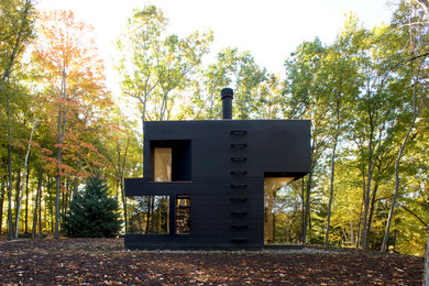 Example of a minimalist black two-story exterior home design in New York