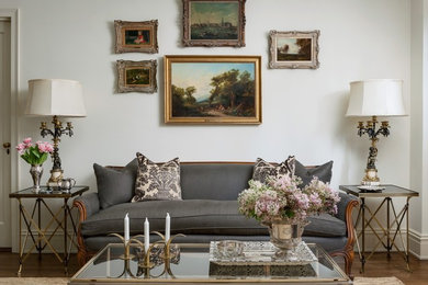 Inspiration for a timeless formal medium tone wood floor and brown floor living room remodel in New York with white walls