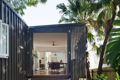 Photo of a contemporary one-storey black exterior in Brisbane with metal siding and a shed roof.