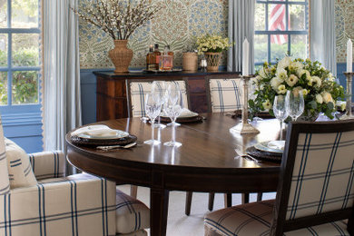 Elegant dark wood floor, brown floor and wallpaper kitchen/dining room combo photo in Los Angeles with blue walls