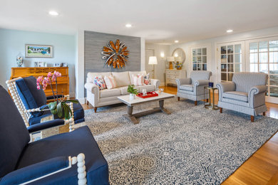 Living room - large coastal open concept medium tone wood floor, brown floor and wallpaper living room idea in Boston with blue walls, a standard fireplace, a shiplap fireplace and no tv