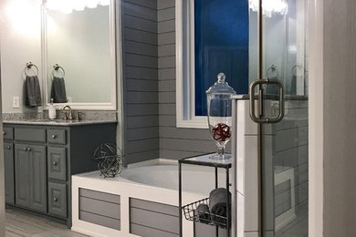 Example of a large transitional kids' gray tile and porcelain tile ceramic tile and gray floor bathroom design in Dallas with raised-panel cabinets, gray cabinets, gray walls, an undermount sink, granite countertops, a hinged shower door and gray countertops