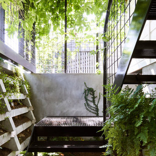 Inspiration for a modern metal floating metal railing staircase in Brisbane with open risers.