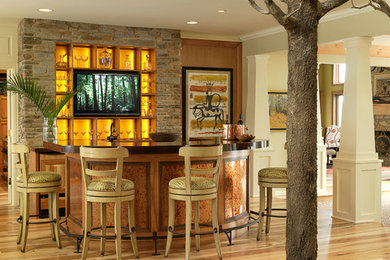 Inspiration for a transitional light wood floor home bar remodel in St Louis
