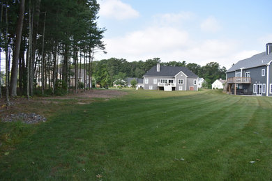Inspiration for a mid-sized contemporary full sun backyard mulch formal garden in Providence with a fire pit for summer.