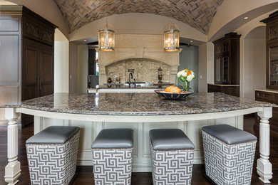 Eat-in kitchen - large transitional l-shaped dark wood floor eat-in kitchen idea in Other with a farmhouse sink, shaker cabinets, dark wood cabinets, wood countertops, multicolored backsplash, stone tile backsplash, stainless steel appliances and two islands