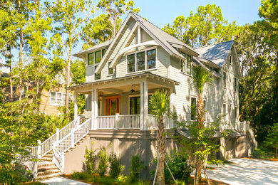 Example of a large transitional gray two-story concrete house exterior design in Charleston with a metal roof