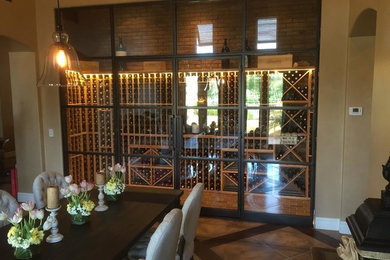 This is an example of a medium sized classic wine cellar in Phoenix with brick flooring, storage racks and brown floors.