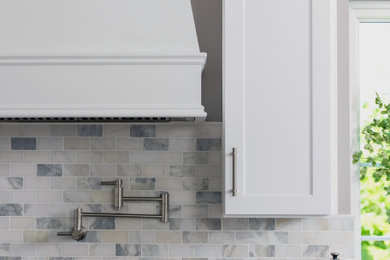 Kitchen - modern kitchen idea in Charlotte with shaker cabinets, white cabinets and an island