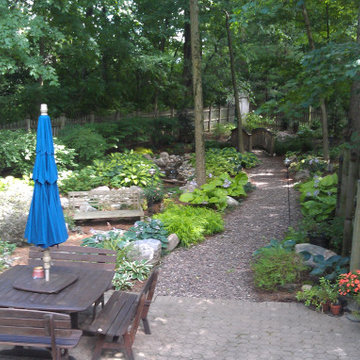 Shady Backyard with Waterfall, Stream, Fireplace and Landscape