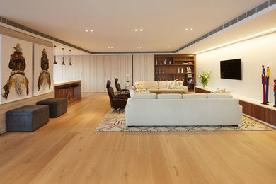 Photo of a large contemporary enclosed living room in Sydney with a wall-mounted tv.