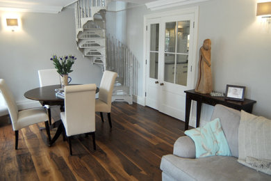 Photo of a medium sized open plan living room in Cambridgeshire with laminate floors and brown floors.