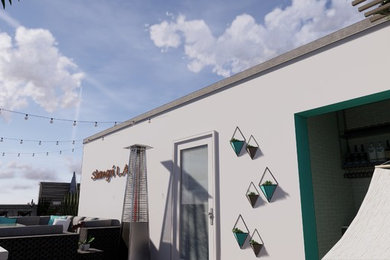 Inspiration for a small modern courtyard patio kitchen remodel in Los Angeles with decking and a roof extension