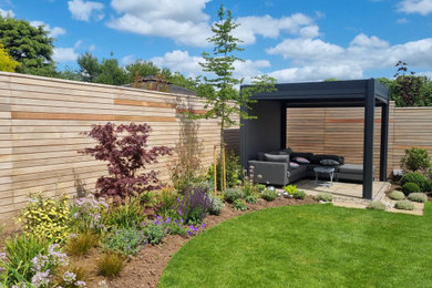 Contemporary Cedar Slatted Fence in pretty modern planted garden