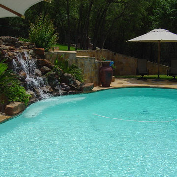 Pool with Moss Rock Waterfall and Flagstone Deck
