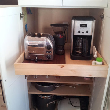 Appliance counter within a pantry cabinet